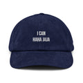 A navy blue corduroy baseball cap with white embroidered text reading 'I CAN HAHA JAJA' on the front, shown against a plain white background.