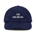 A navy blue corduroy baseball cap with white embroidered text reading 'I CAN HAHA AND JAJA' on the front, shown against a plain white background.
