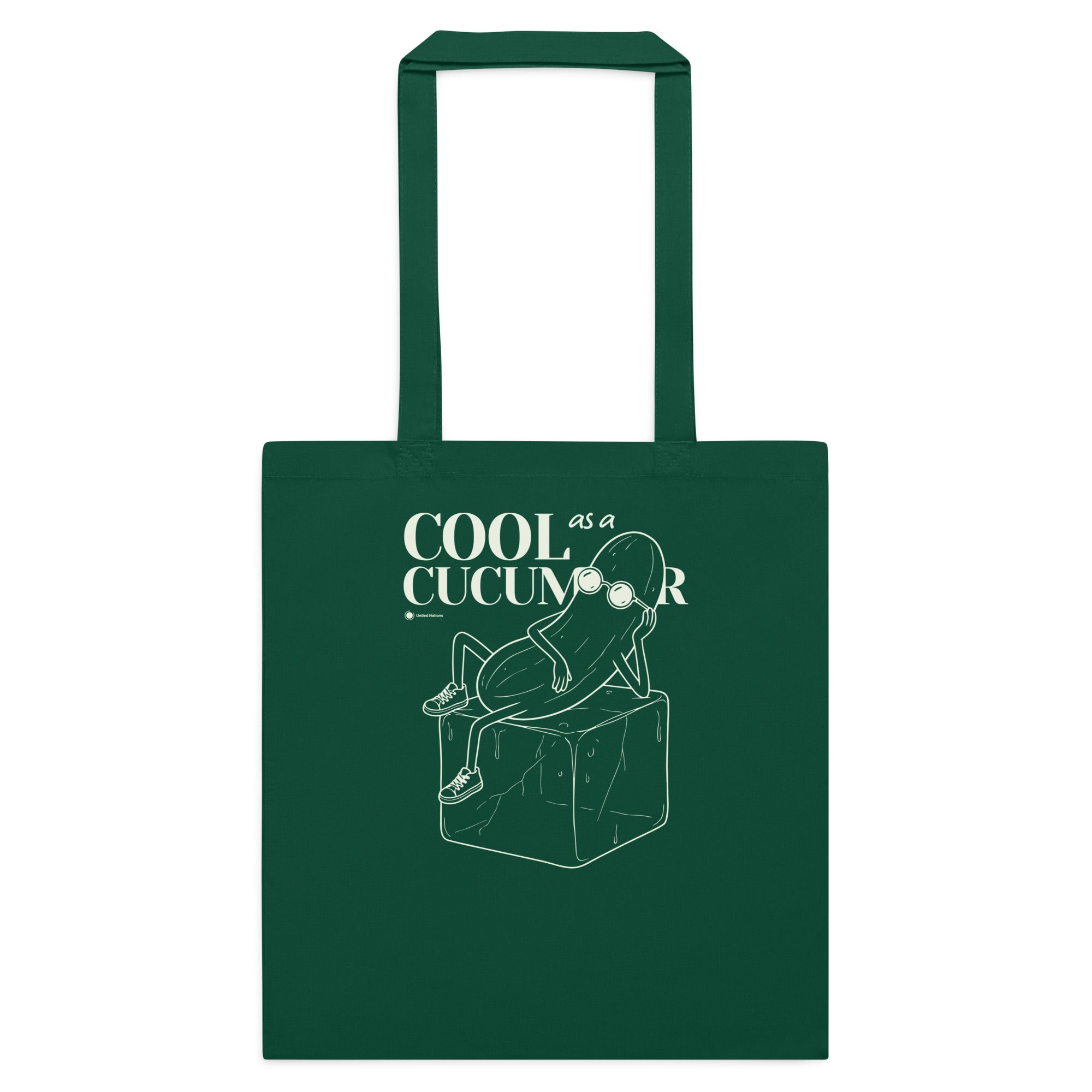 A dark green canvas tote bag with two handles, featuring a white line art graphic of a cucumber sitting on a block with the text 'COOL as a CUCUMBER' printed on the front, set against a plain white background.