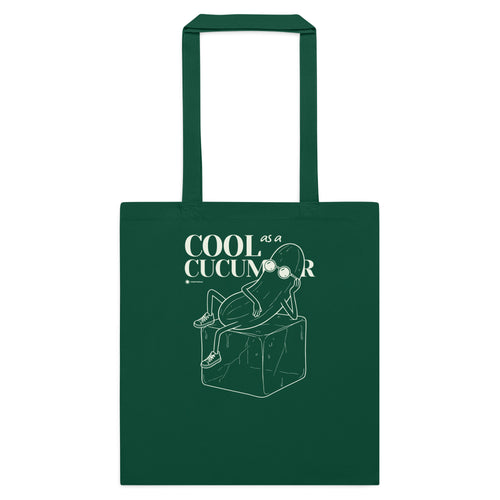 A dark green canvas tote bag with two handles, featuring a white line art graphic of a cucumber sitting on a block with the text 'COOL as a CUCUMBER' printed on the front, set against a plain white background.