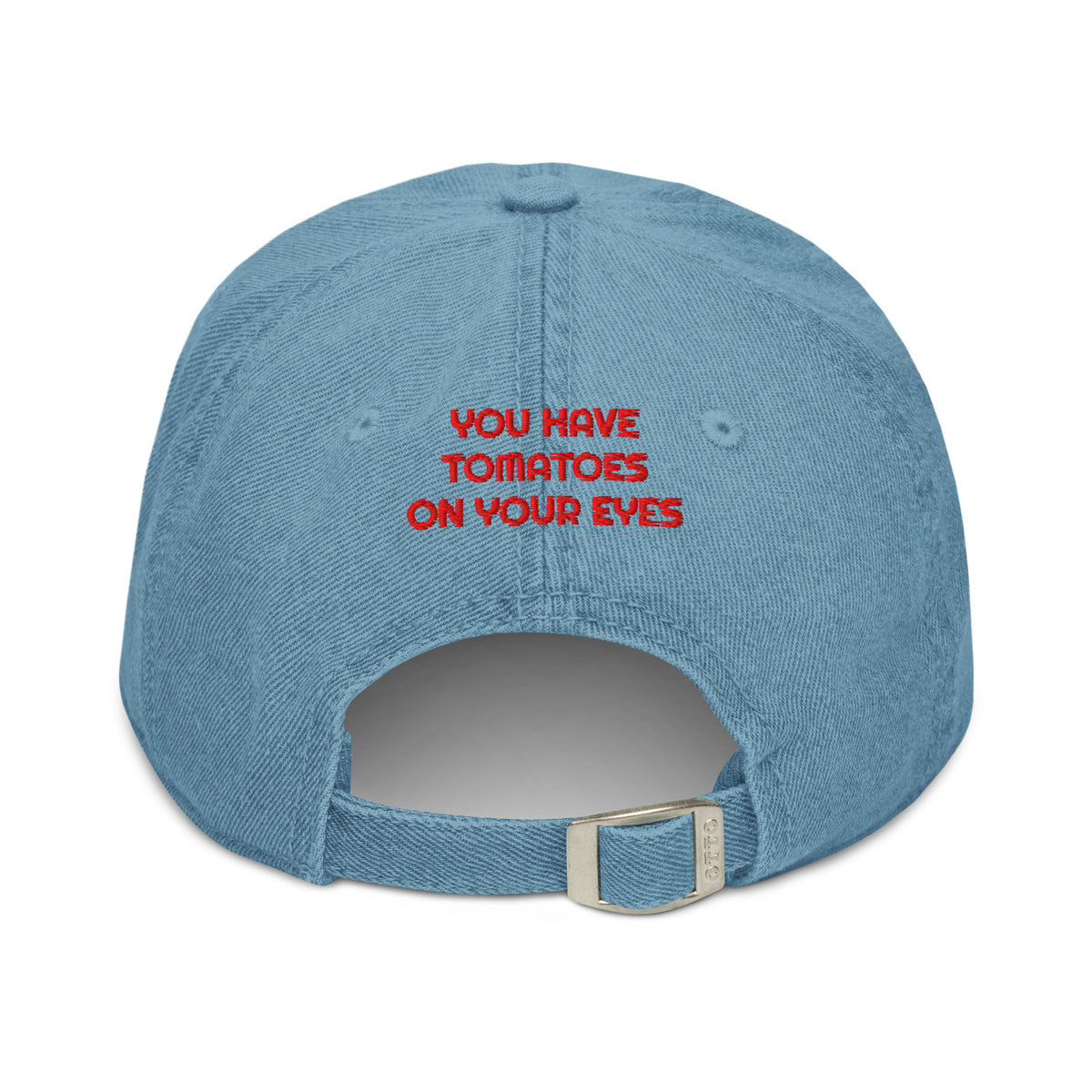 A light blue denim baseball cap shown from the back, featuring the phrase 'YOU HAVE TOMATOES ON YOUR EYES' embroidered in red on the back. The cap has an adjustable strap with a silver metal buckle.