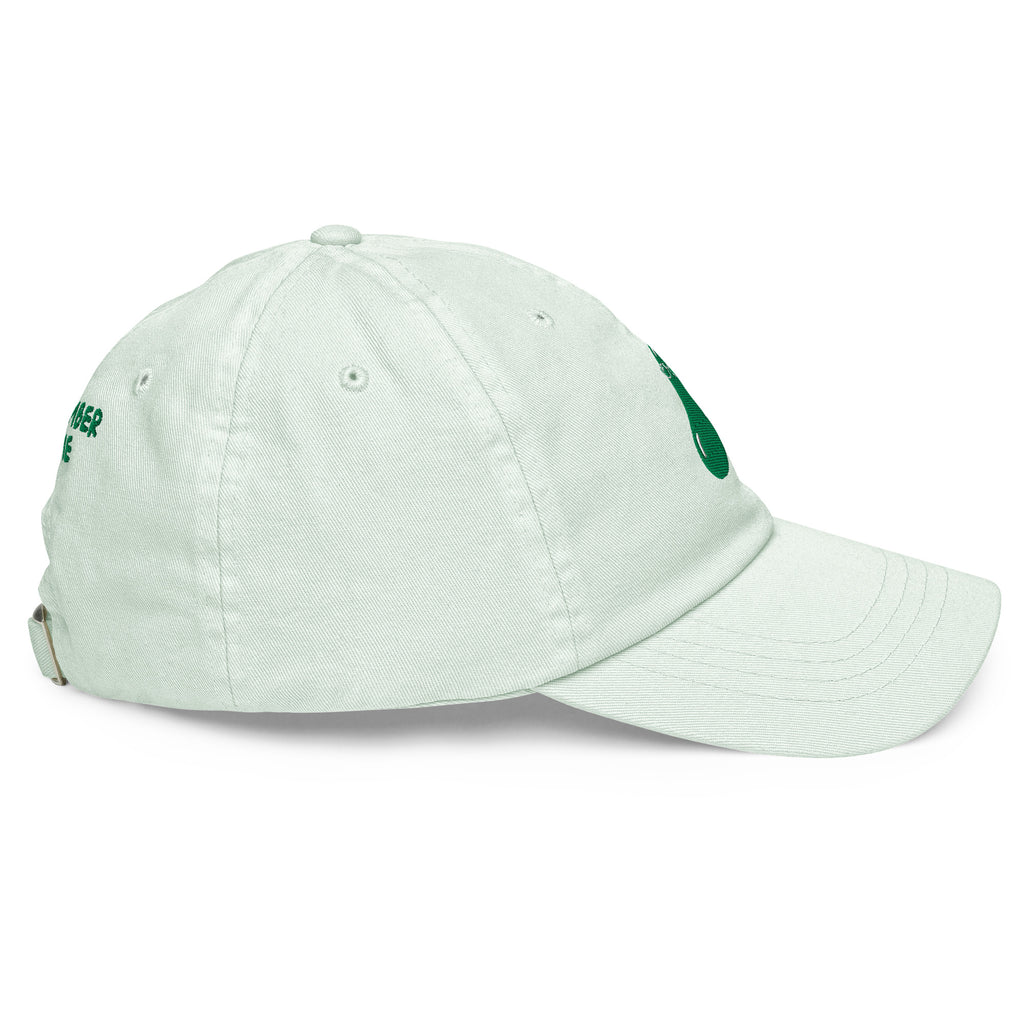A light mint green baseball cap with green embroidered lettering on the side, shown from a three-quarters angle on a white background.