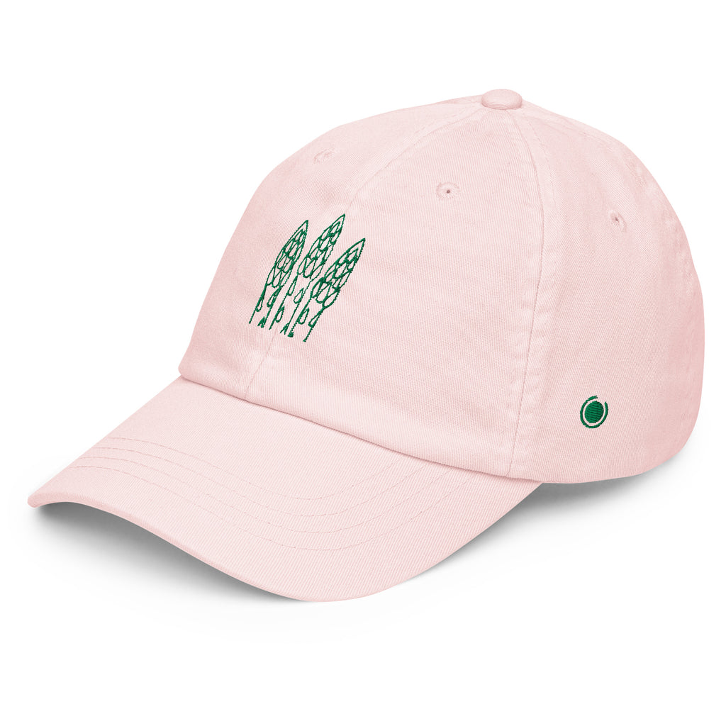 A light pink baseball cap with green embroidered asparagus graphics on the front and a small green circular logo on the side, shown on a clean white background.
