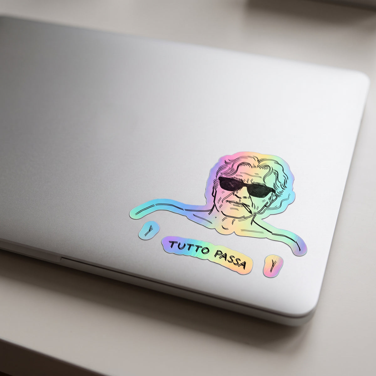 tutto passa holographic sticker on laptop