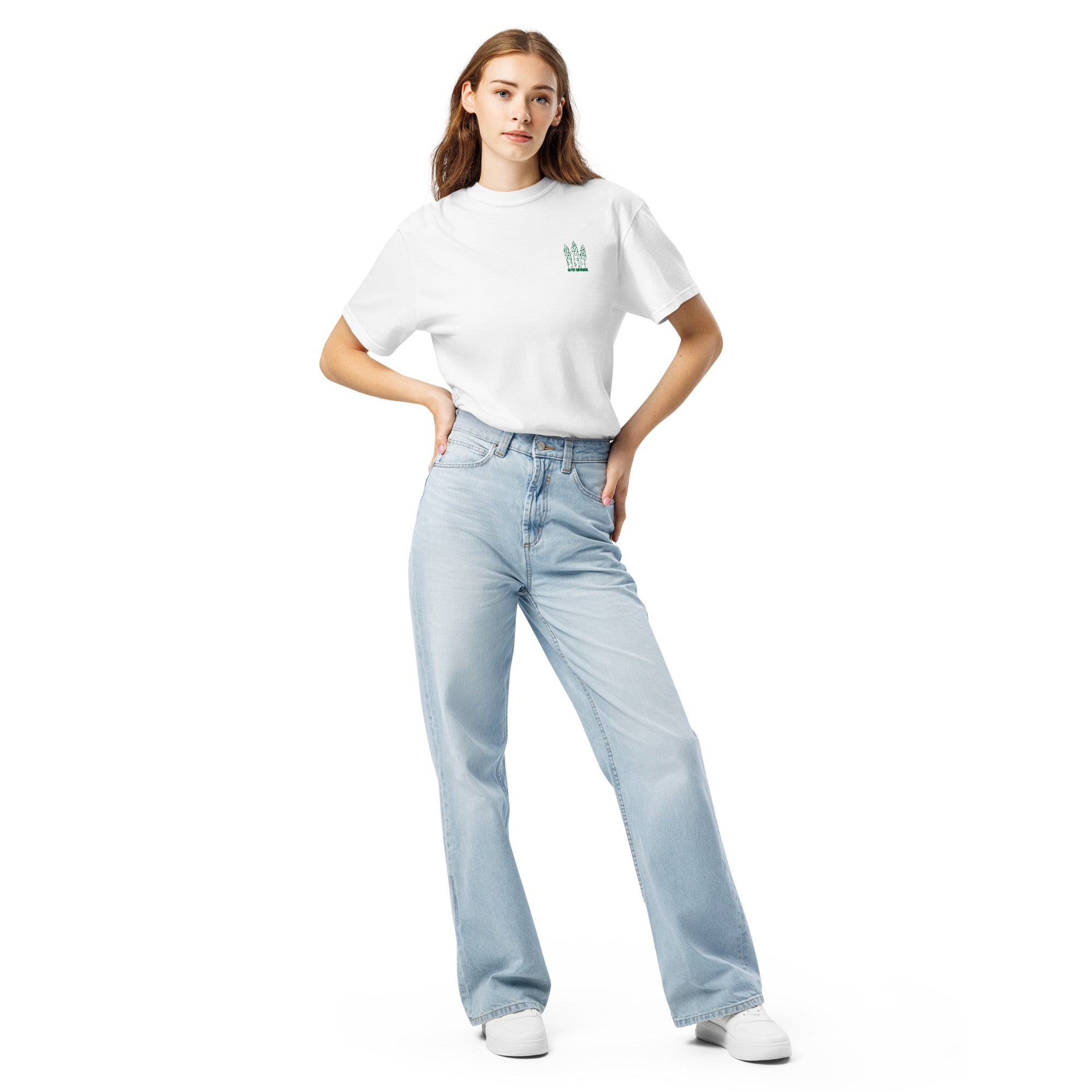 Woman wearing a white t-shirt with an illustration of asparagus and the text "Go fry asparagus" embroidered on the front left chest and light blue jeans on a white background