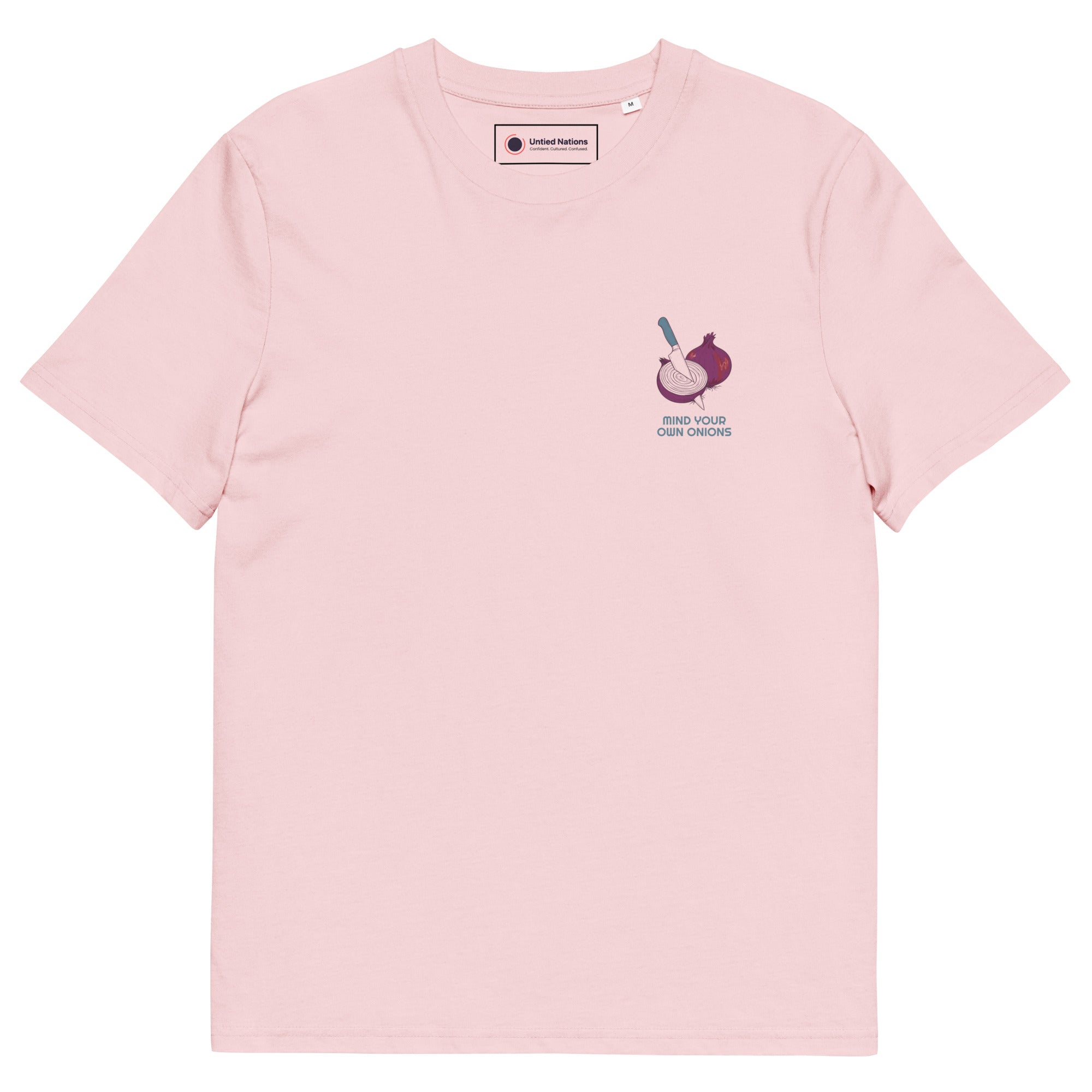 A light pink crewneck t-shirt with a small graphic on the left chest depicting a sliced red onion with a knife and the text 'MIND YOUR OWN ONIONS'.