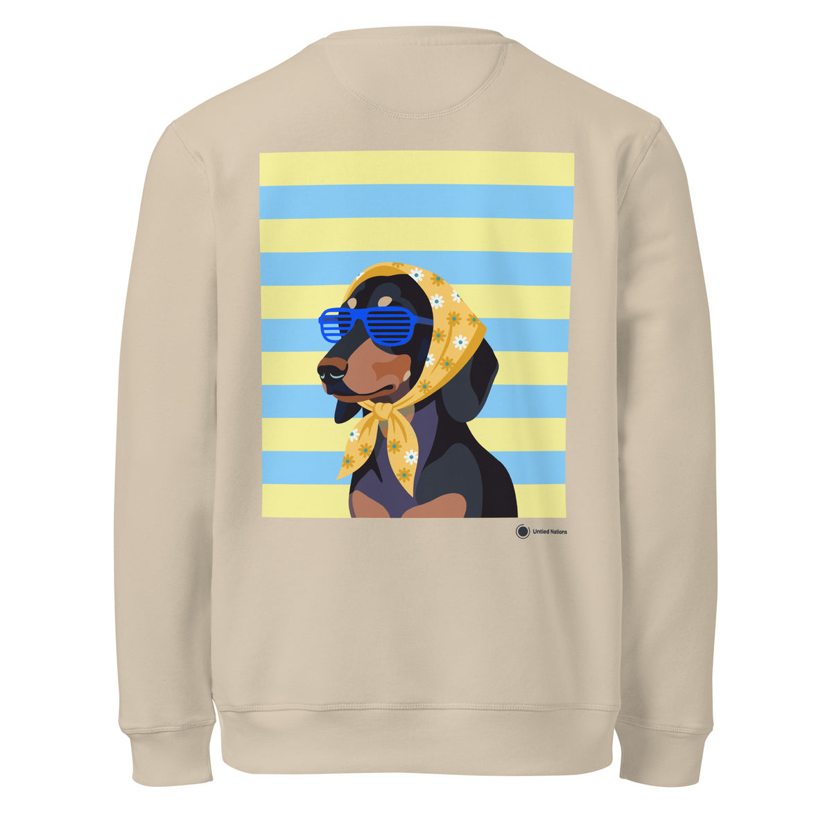 A beige crewneck sweatshirt featuring a graphic print of a dachshund wearing blue sunglasses and a yellow bandana with white daisy flowers, set against a background of yellow and blue horizontal stripes.