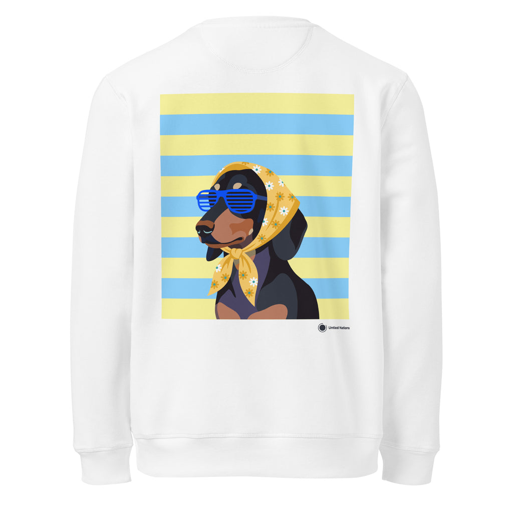 A white crewneck sweatshirt shown from the back, featuring a large graphic print of a black and tan dog wearing a yellow bandana with white daisy flowers and blue sunglasses, set against a background of yellow and blue horizontal stripes.