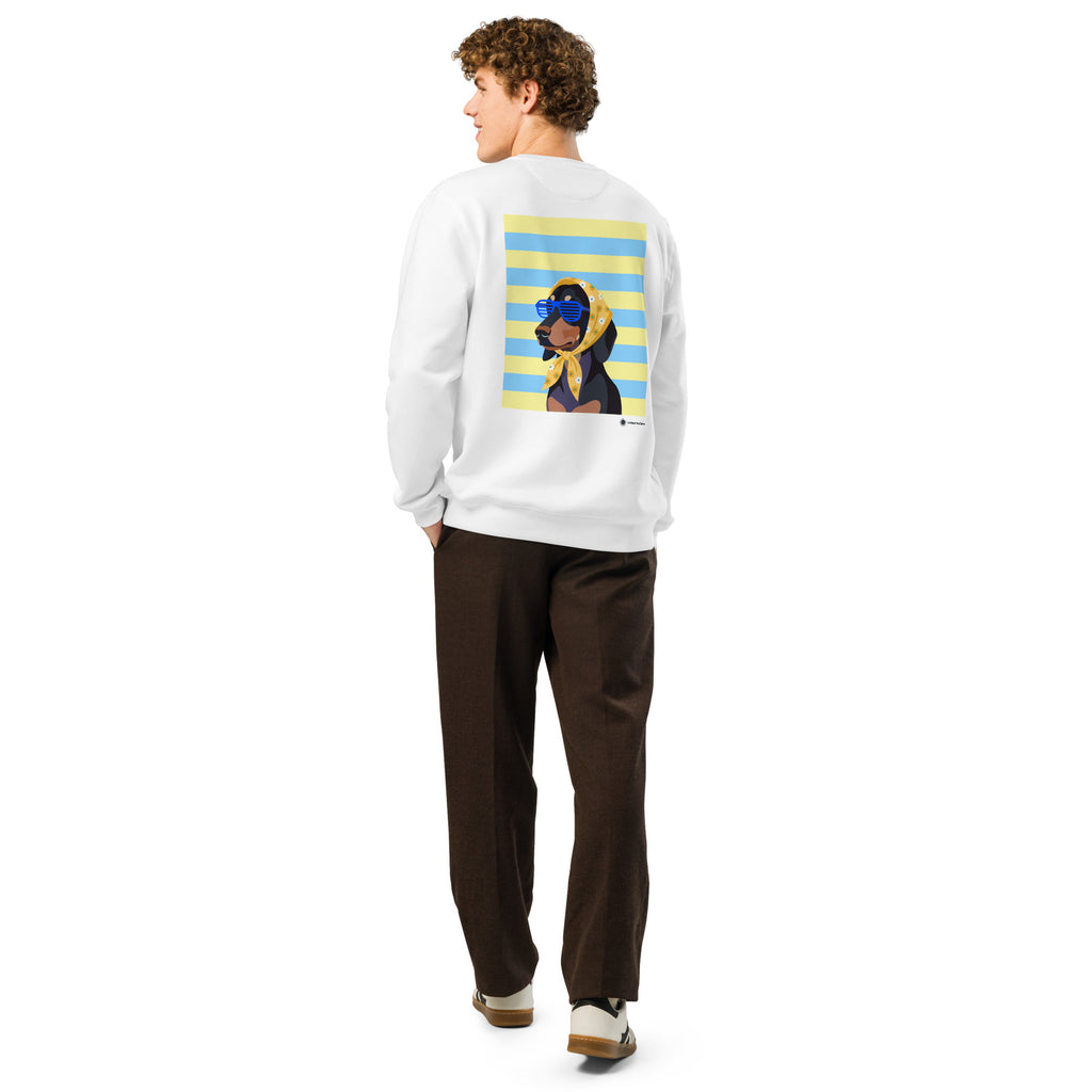 A man shown from the back wearing a white crewneck sweatshirt with a large graphic print of a cartoon dog on a yellow and blue striped background, paired with dark brown trousers and white sneakers.