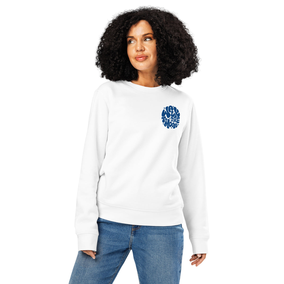 Woman wearing white crew neck sweater with blue embroidery