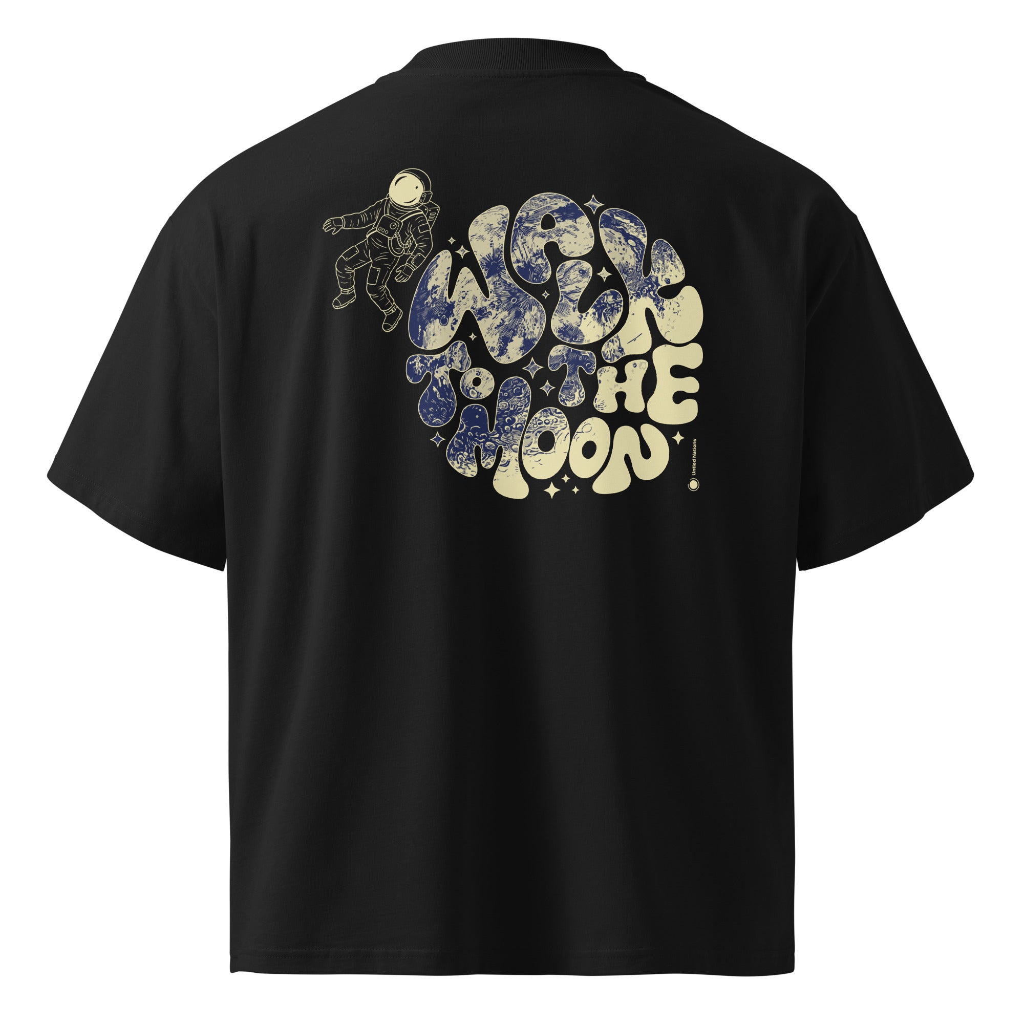 A black short-sleeve t-shirt shown from the back, featuring a large graphic print of an astronaut and the words 'WALK TO THE MOON' in a retro bubble font with a blue and cream space pattern.
