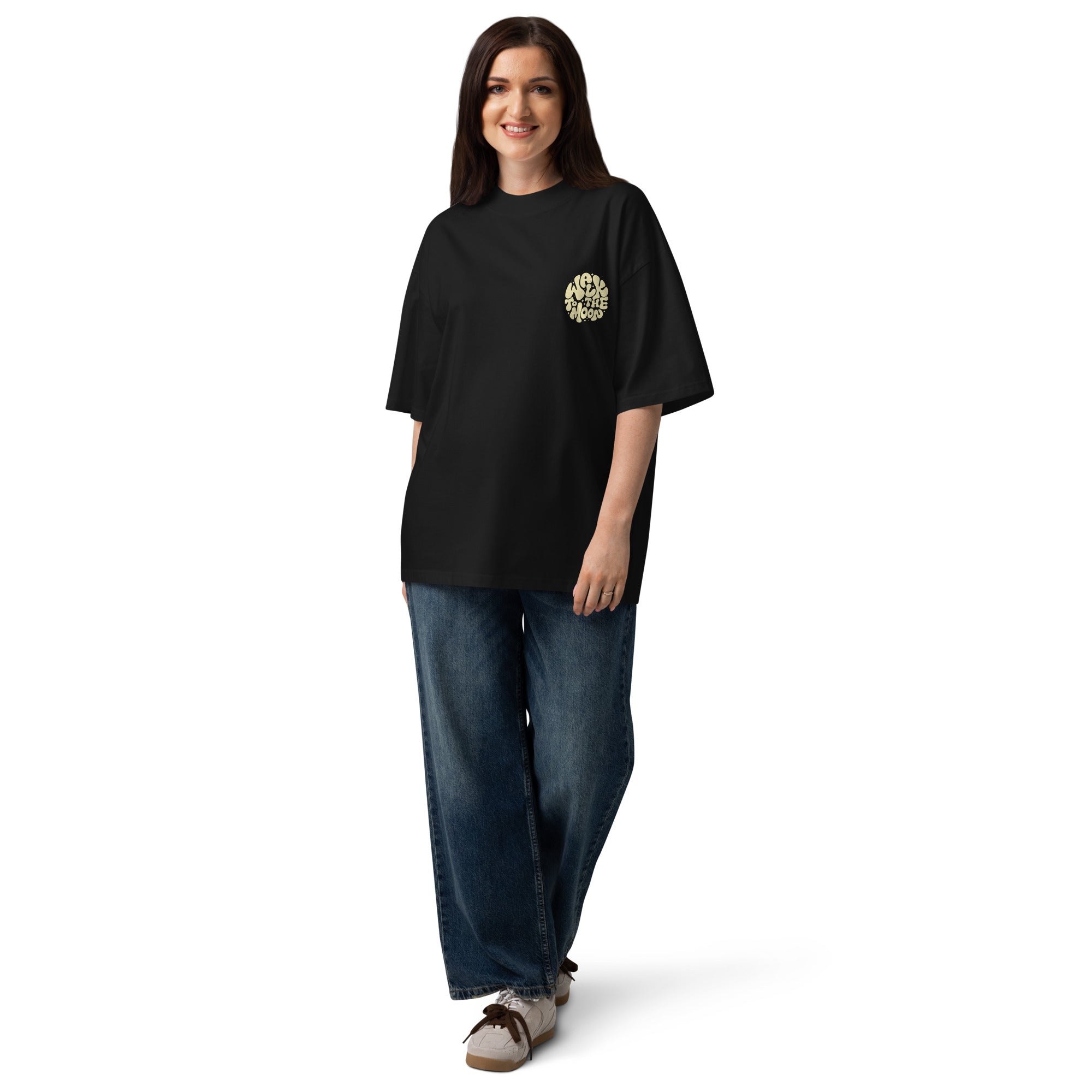 Woman wearing a black t-shirt and blue jeans on a white background