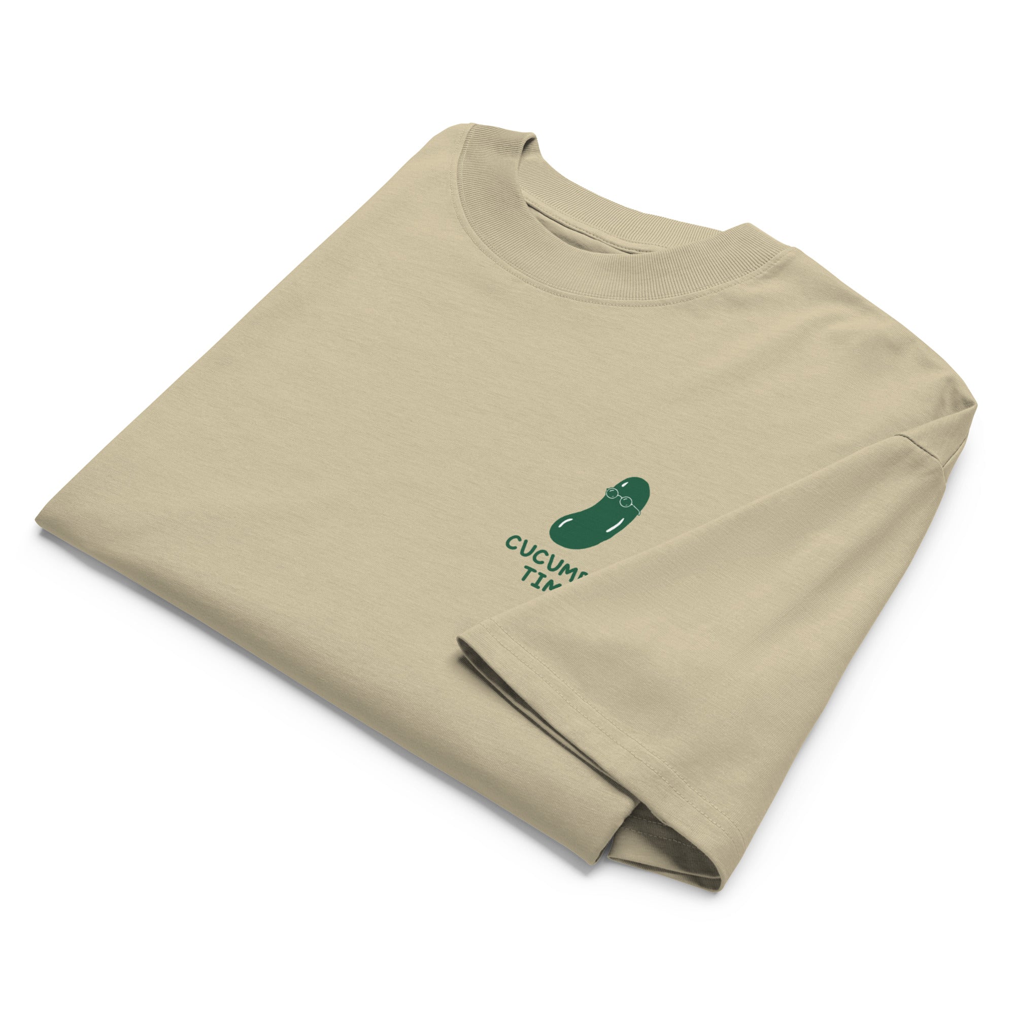 Folded beige t-shirt with a small graphic and text on a white background