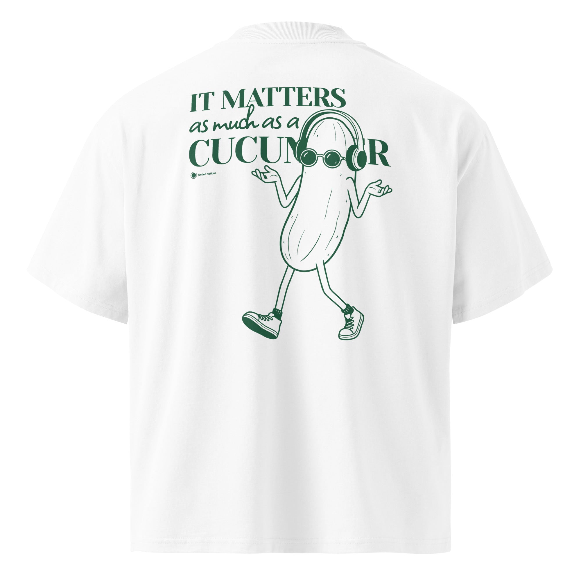 White short-sleeve t-shirt shown from the back, featuring a green graphic of a walking cucumber character wearing glasses and headphones next to the text 'It matters as much as a cucumber'.