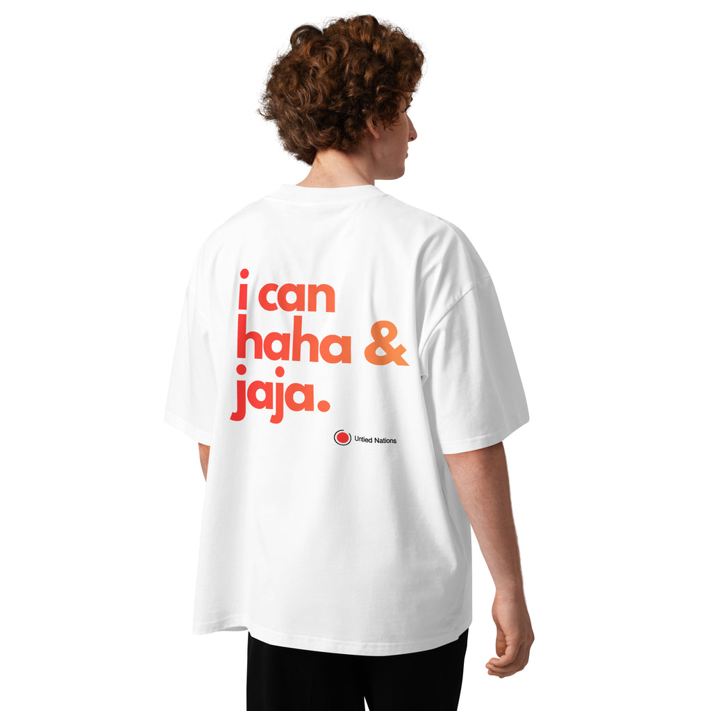 red to orange i can haha and jaja phrase printed on back of white oversized tshirt worn by man