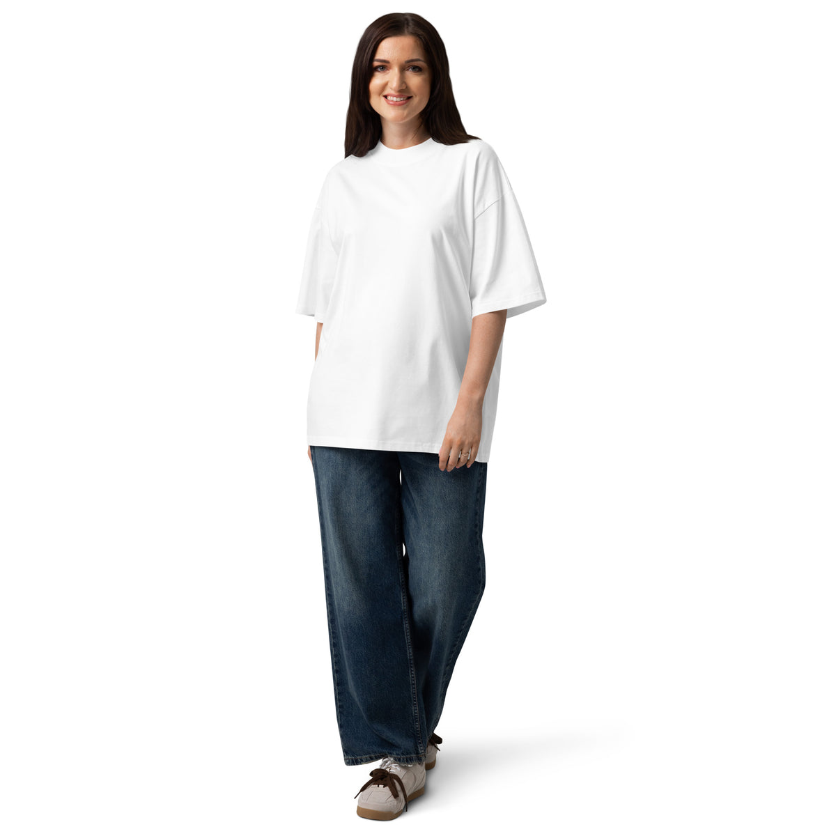 Woman wearing a white t-shirt with a logo and blue jeans on a white background