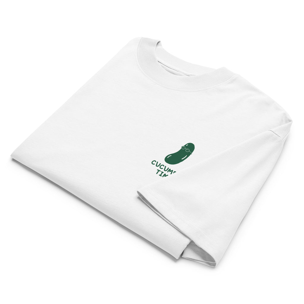 A folded white long-sleeve t-shirt with a small green pickle graphic and the text 'CUCUMBER TIME' printed on the chest, displayed on a clean white background.