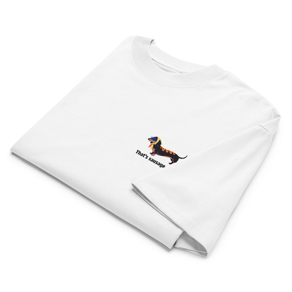 A folded white long-sleeve t-shirt with a small graphic of a dachshund wearing sunglasses and the text 'That's sausage to me' printed on the chest, displayed on a clean white background.