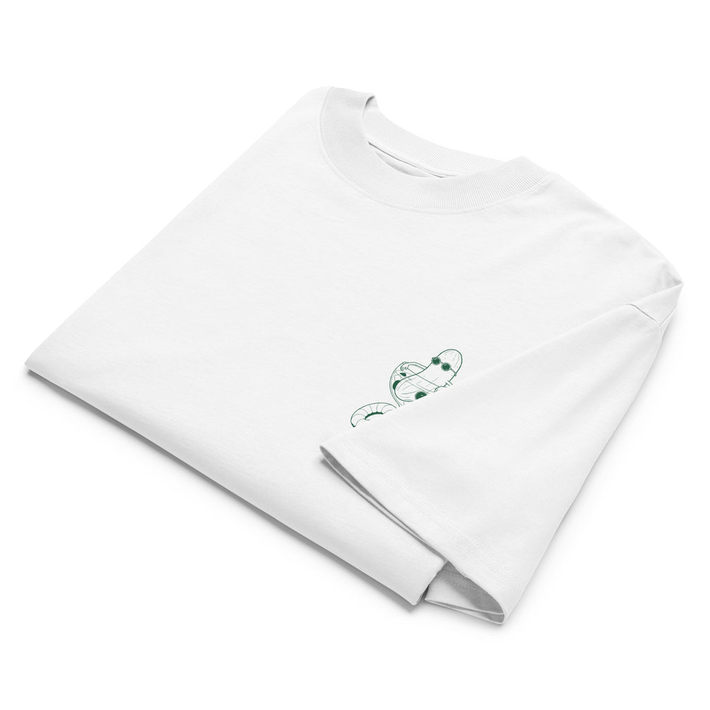 A folded white short-sleeve crewneck t-shirt with a small green illustration of a cucumber wearing sunglasses and sitting in a cocktail glass printed on the left chest.