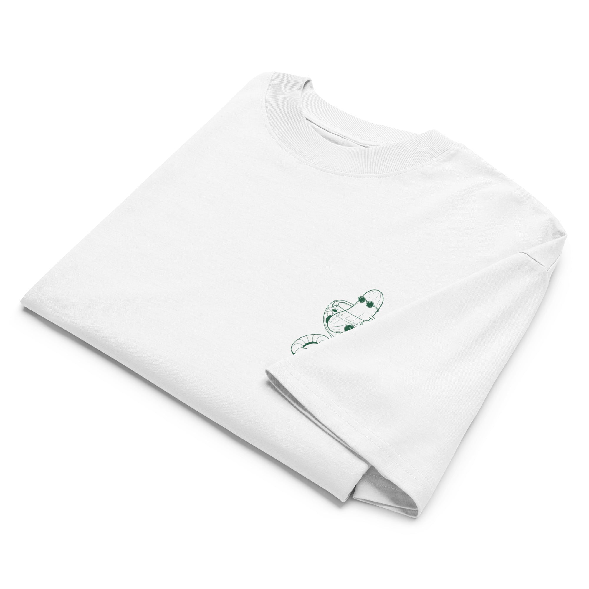 A folded white short-sleeve crewneck t-shirt with a small green illustration of a cucumber wearing sunglasses and sitting in a cocktail glass printed on the left chest.