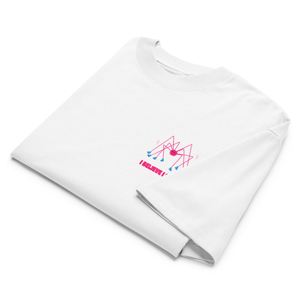 A folded white oversized graphic tshirt with a pink spider wearing roller skates and the text "I believe I spider" printed on the left chest