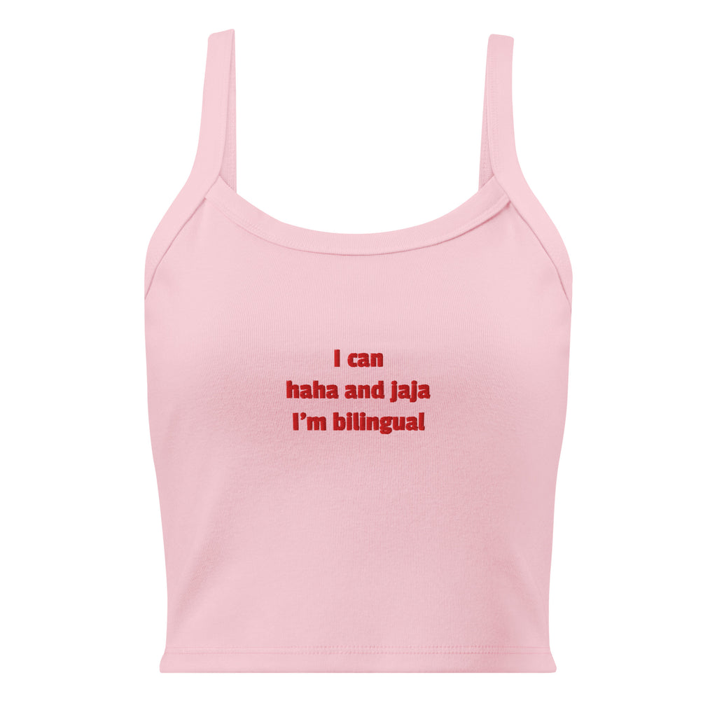 A light pink sleeveless crop top with thin straps and red text on the chest that reads 'I can haha and jaja I'm bilingual'.